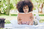 Picnic, park and reading black woman with book relax for outdoor education, studying and wellness. Black woman notebook for free time leisure, learning or nature self care notes tips with trees bokeh