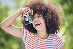 Nature, afro and black woman with photography camera  taking happy picture memory with retro style. African hipster girl with smile in park using vintage photographer equipment to capture moment.


