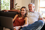 Laptop, couple and retirement with a man and woman streaming an online subscription service on the sofa to relax. Computer, living room and internet with an elderly male and female watching a video