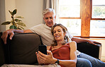 Elderly, couple and phone together on sofa for social media, video or blog on internet with smile on face. Senior, man and woman with smartphone in living room for communication, meme or chat on app
