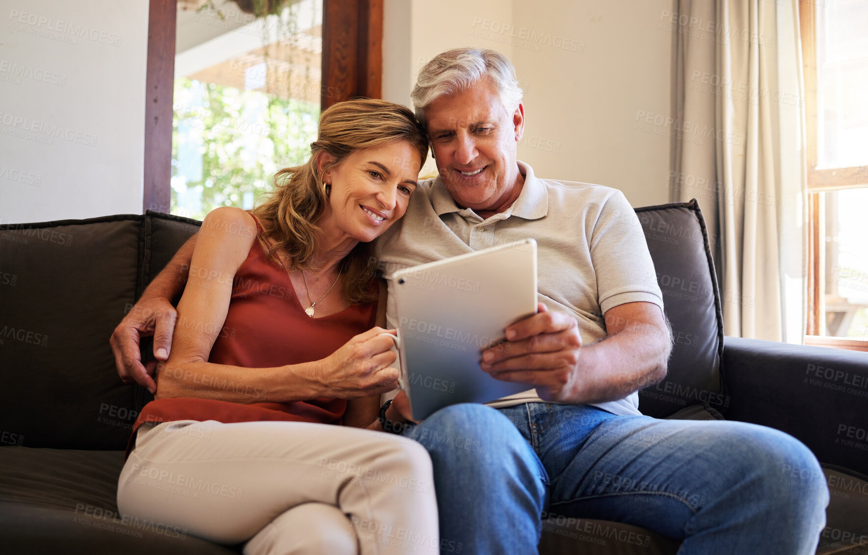 Buy stock photo Tablet, movie and senior couple streaming a film on the internet from the living room sofa of their house. Happy elderly man and woman on a subscription service website for a film with tech on couch