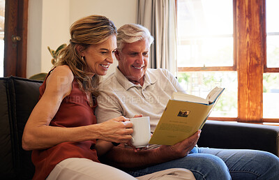 Buy stock photo Book, relax and senior couple reading a story together with coffee on the living room sofa of their house. Elderly man and woman with smile for knowledge from literature with tea on the couch