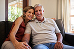 Portrait, relax and senior couple with smile on the living room sofa of their house in retirement. Happy elderly man and woman bonding in marriage with love, affection and happiness on the couch