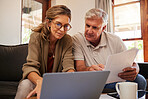 Retirement couple budget, finance and investment planning, loan and paper bills with laptop technology in home. Mature people money, cash savings or legal insurance document report on online bank
