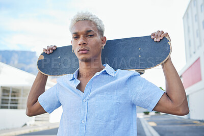 Buy stock photo Black man, serious with a skateboard and city, urban background and trendy, hipster fashion in portrait. Young African American hobbies, skater and gen z youth outdoors at skatepark during summer.