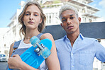 Skateboard, couple and city with a man and woman skating outdoor in a town together during summer. Portrait, skater and diversity with a young male and female looking serious on an urban background