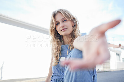 Buy stock photo Portrait of girl in the city with hand reaching forward, sitting in the street. Student, education and young woman in college with hands out in urban road. Motivation, encourage and freedom in youth