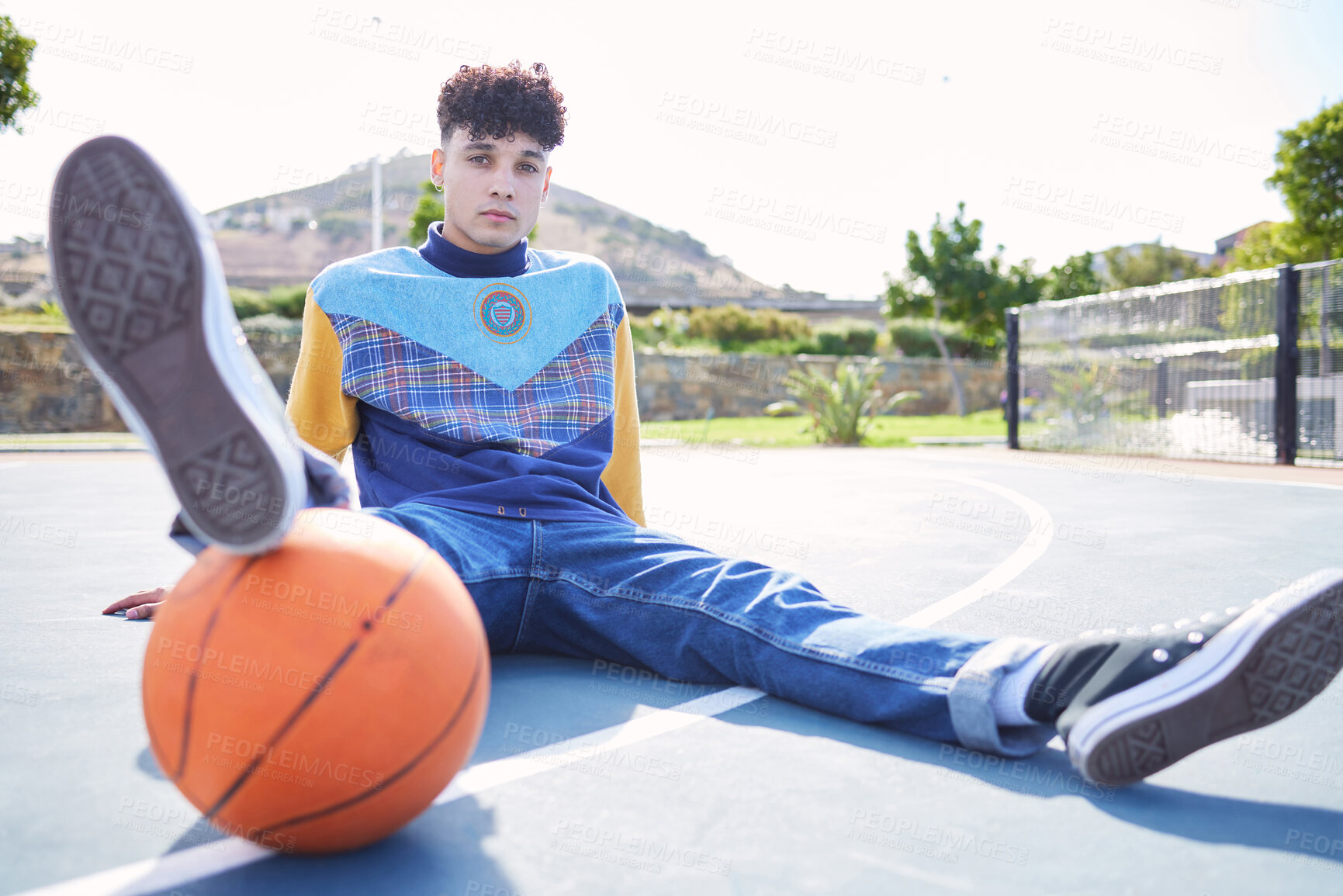 Buy stock photo Basketball, fashion and portrait of a trendy model sitting on the floor of outdoor court. Edgy, stylish and cool man or influencer with a sports ball relaxing on outside sport field in the urban city
