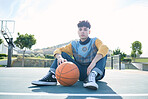 Man, basketball and training sitting on basketball court for rest, relax or breathe during practice. Basketball player, workout and sports for game in park for sport, fitness and physical health