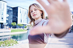 Portrait of woman in the city with hand reaching, standing in the street. Fashion, beauty and makeup in trendy young girl in the road of urban town with hand out to frame style model face in summer