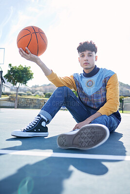 Buy stock photo Basketball, court and portrait of a man model sitting on the ground with stylish, trendy and cool clothes. Sports, relax and guy from Canada holding a ball on outdoor training field in the urban city