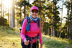 Hiking, nature and summer with a senior woman in the forest or woods, walking for health and exercise. Trees, fitness and hike with an elderly female pensioner taking a walk in the mountain in summer