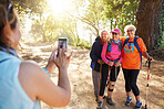Phone, photograph senior women hiking group in forest on summer holiday weekend. Nature, elderly girl friends and walk on adventure trail. Friendship, fun and fitness in retirement hike in the forest