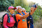 Senior women, phone selfie and hiking in nature on holiday or summer vacation. Travel, hike and retired friends spending time together on 5g mobile tech, happy memory or picture post for social media