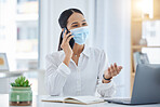 Covid, call and mask with a business woman at work in her office on laptop while talking on a phone. Mobile, communication and networking with a young female employee remote working alone at a desk