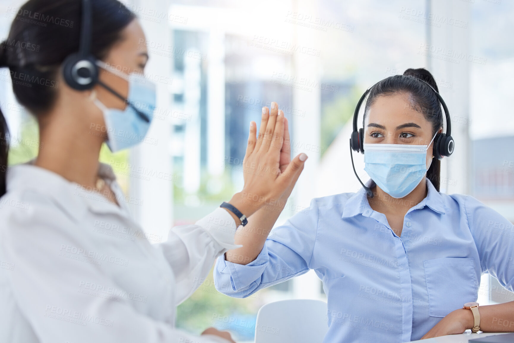 Buy stock photo Covid, high five and women in call center with face mask for office compliance, target success or goal achievement. Sales, telemarketing or e commerce business people hands teamwork, support and care