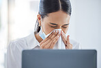 Covid, sick and blowing nose with a business woman sneezing into a tissue while suffering with a cold, flu or allergies in the office. Hands, nasal and hayfever with a young female employee at work