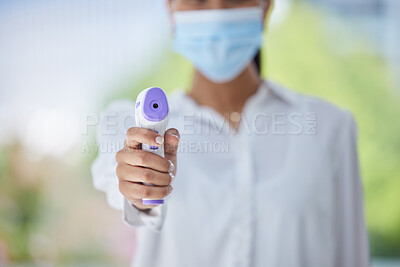 Buy stock photo Covid, hand and health thermometer in office, healthcare or wellness check from a employee. Woman work with medical equipment to document fever for disease, dengue fever or corona scan at a workplace