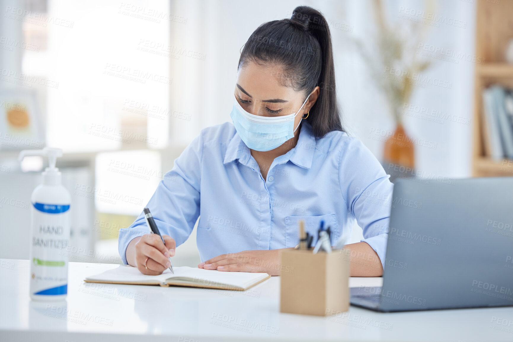 Buy stock photo Covid, laptop and business woman writing in notebook, planning schedule or meeting agenda in office. Corporate manager, employee or worker with book for proposal, working on idea with a face mask
