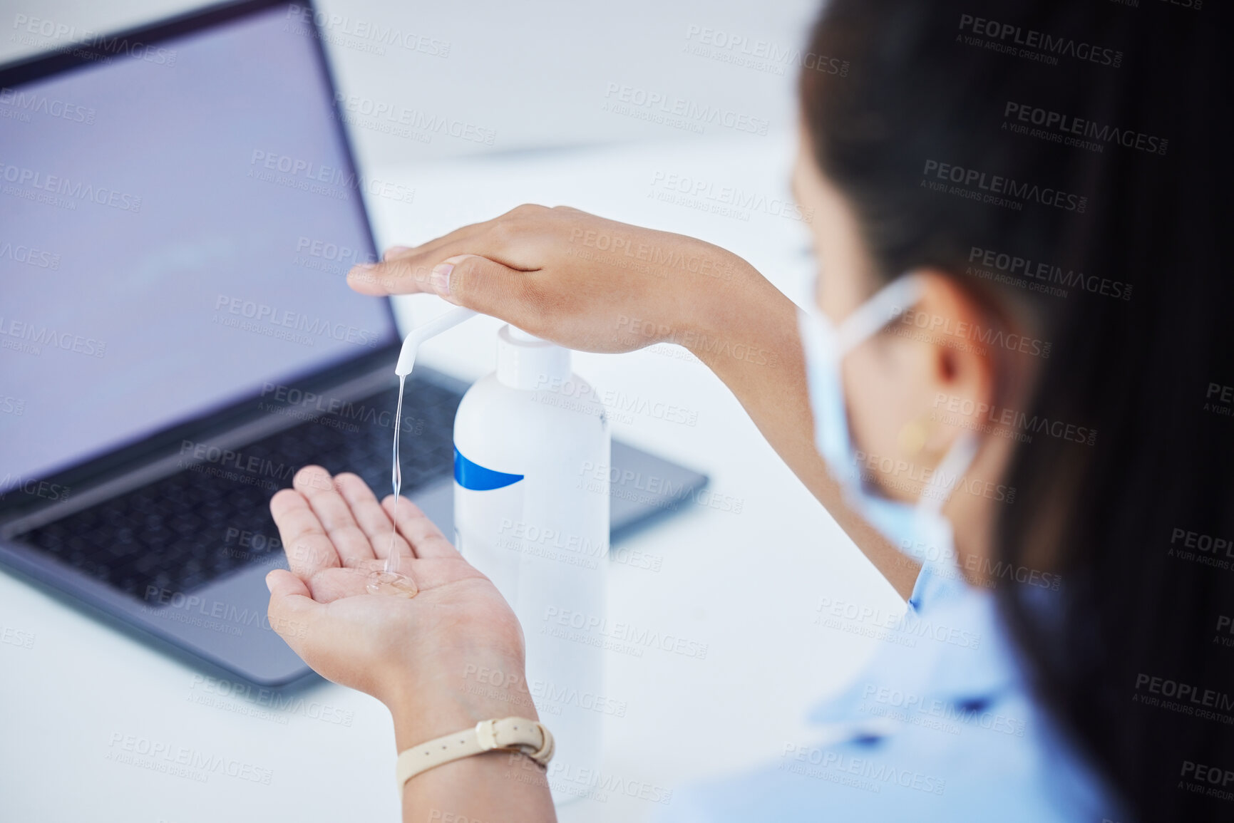 Buy stock photo Covid, hand sanitizer and a woman with laptop and face mask in office. Online work, hygiene and a businesswoman with alcohol spray on hands at desk. Safety, working and cleaning hands during pandemic