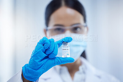 Buy stock photo Covid, innovation and woman scientist with the vaccine or virus cure in a medical laboratory after research analysis. Face mask, safety and healthcare science doctor holding antivirus medicine 