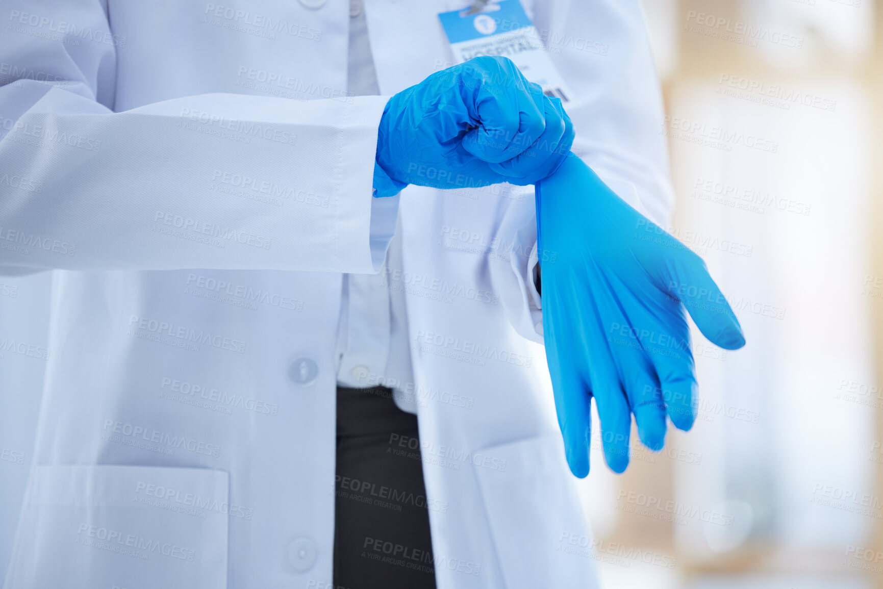Buy stock photo Hands, gloves and healthcare with a doctor you can trust working alone in a hospital. Health, insurance and medical with a medicine professional putting on a rubber or latex glove for safety