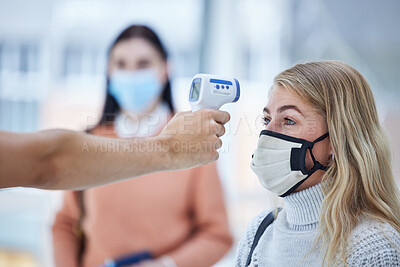 Buy stock photo Covid, travel and safety thermometer security test at airport for healthcare protocol inspection. Travelling woman with face mask for coronavirus fever check with medical screening worker.
