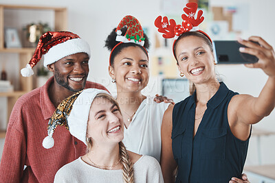 Buy stock photo Christmas party, phone selfie and business people in celebration of festive holiday. Diversity, smile and happy work friends celebrating on 5g mobile, social media picture post or happy office memory