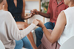 Trust, community and group of people holding hands in therapy counseling session for mental health. Empathy, diversity and support of friends praying together at addiction treatment center or clinic.