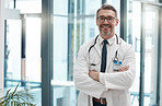 Mature man, arms crossed and doctor in hospital, healthcare and wellness clinic with trust, vision or help motivation. Portrait, smile or happy consulting medical worker or surgery insurance employee