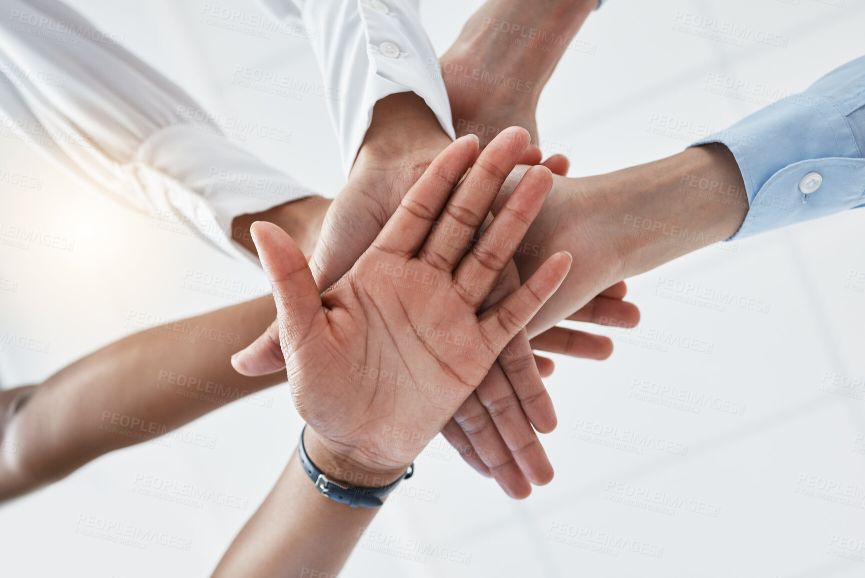 Buy stock photo Hands, collaboration and motivation with a team in business standing in a huddle or circle from below. Teamwork, success and unity with an employee group working together with a goal or vision