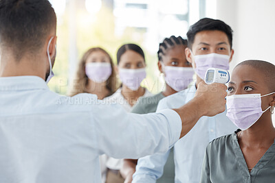 Buy stock photo Covid compliance, business and people with face mask testing with thermometer at security to check symptoms for office policy. Diversity, employees and corona virus safety for men and women at work