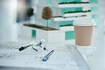 Architecture, planning and design on desk with drawing tools, safety glasses and coffee. Blueprint, vision and ideas for architect, engineer or construction worker, mockup for construction industry