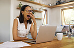 Woman, tired and yawn with laptop for remote work at table in home. Girl, glasses and burnout for stress, business or work for job in marketing, finance or trading on internet, social media or web