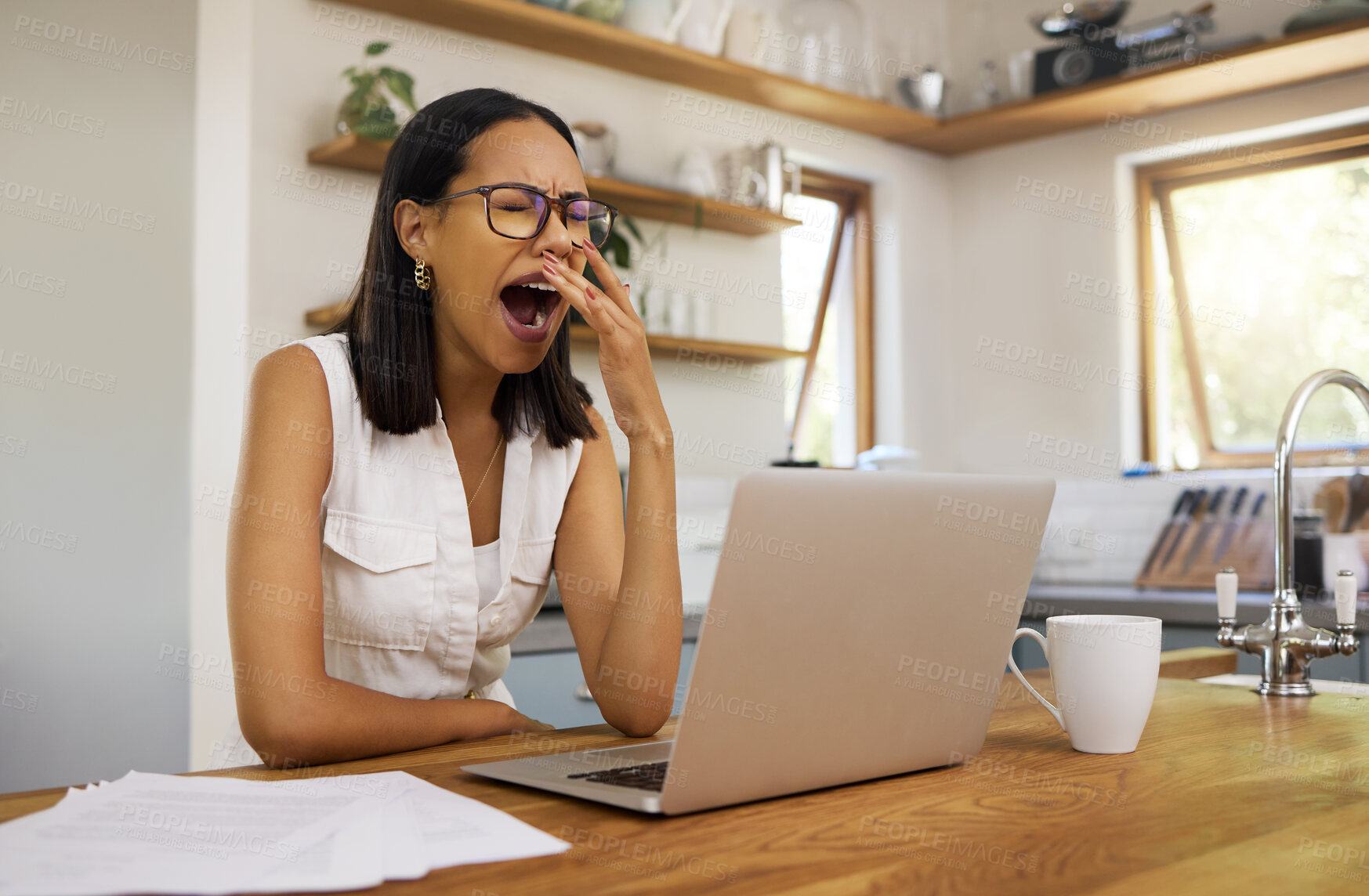 Buy stock photo Woman, tired and yawn with laptop for remote work at table in home. Girl, glasses and burnout for stress, business or work for job in marketing, advertising or seo on internet, social media or web