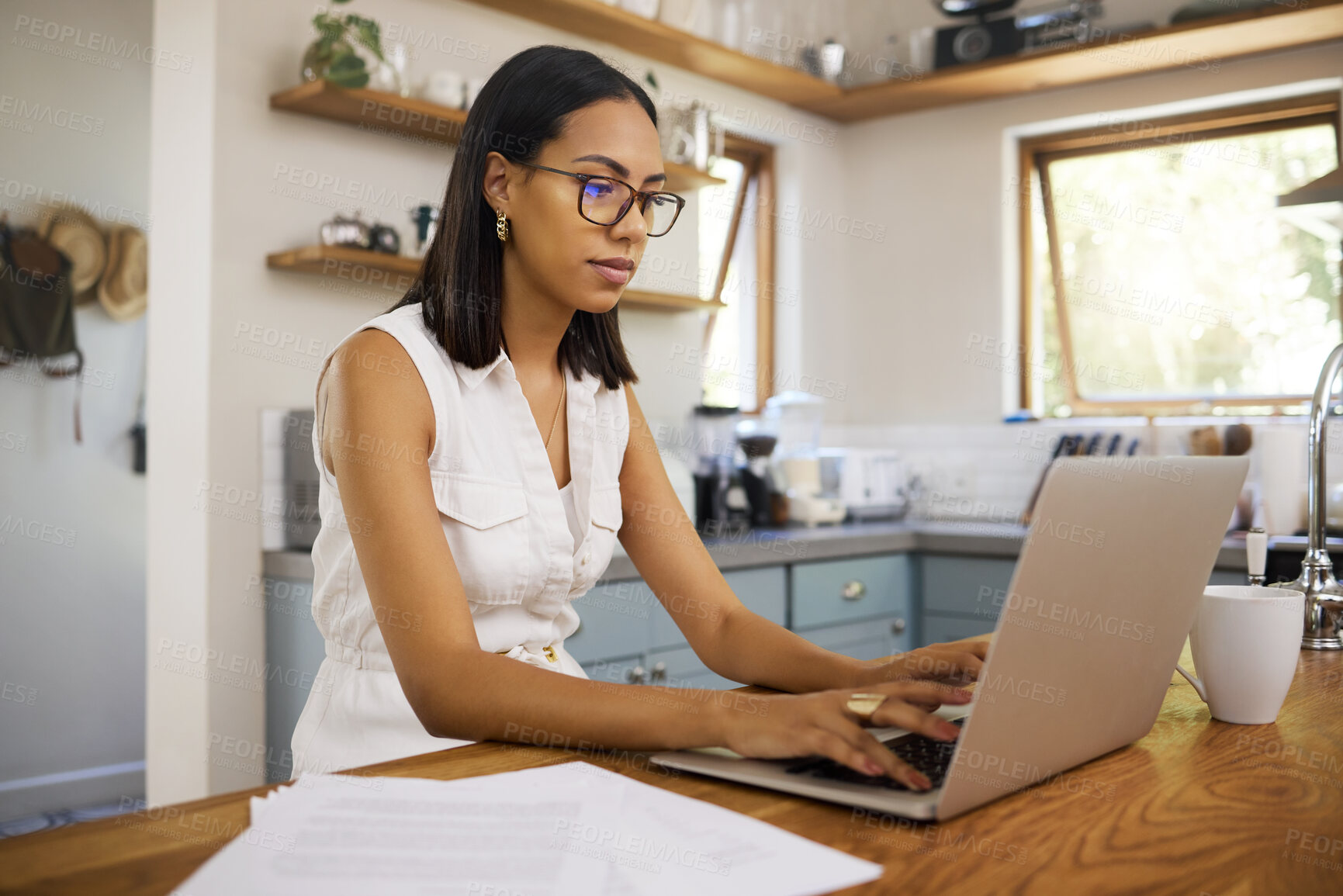 Buy stock photo Woman in business, working on laptop from home and sitting in a kitchen with contract documents on table. Freelance accounting entrepreneur, remote work in house and finance paperwork use 5g internet