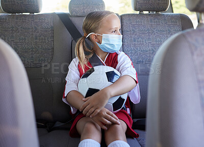 Buy stock photo Covid, soccer and girl in a car to travel in backseat to a youth football training game for exercise and training. Face mask, coronavirus and young child in traffic traveling to a kids sports match