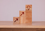 Wood, blocks and idea with light bulb icon for creativity, innovation and development with wooden cubes against studio background. Brainstorming, conclusion and motivation for growth, action or goal