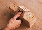 Wood, blocks and game for equality, gender and human rights on table. Lgbt, transgender and pride tolerance with wooden cube with sign for male, female and hand for equal pay, education and learning