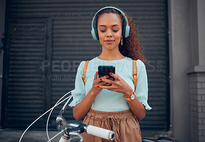 Buy stock photo Music, bicycle and girl on her phone in the city with headphones on. Technology, summer fashion and young woman on her smartphone streaming song, track and radio online and cycling bike in urban town
