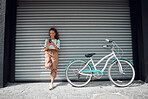 Phone, bicycle and girl on social media in the city browsing or searching for cool and fun street parks outdoors. Smile, bike and happy woman texting on a social network for cycling via the internet