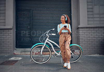 Buy stock photo Phone, bike and city travel for woman with music headphones, podcast or radio in London city. Thinking fashion student, mobile or cool model with eco friendly and future environment energy transport