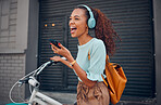 Woman, happy and bicycle with music on phone while on ride in city. Black woman, excited and smile with smartphone for communication, call or streaming on app with bike to reduce carbon footprint