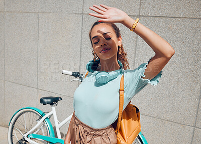 Buy stock photo City, girl and hand shield for sun exposure on outdoor commute break at urban concrete wall. Young bike traveler woman hiding face from direct sunshine for shade protection in summer.

