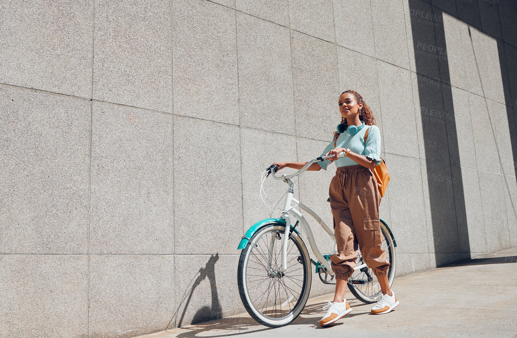 Buy stock photo Bike, urban and city woman on a bicycle ride walking to cut carbon footprint for sustainability. Person relax after riding on a summer day feeling calm and relax with eco friendly transportation 