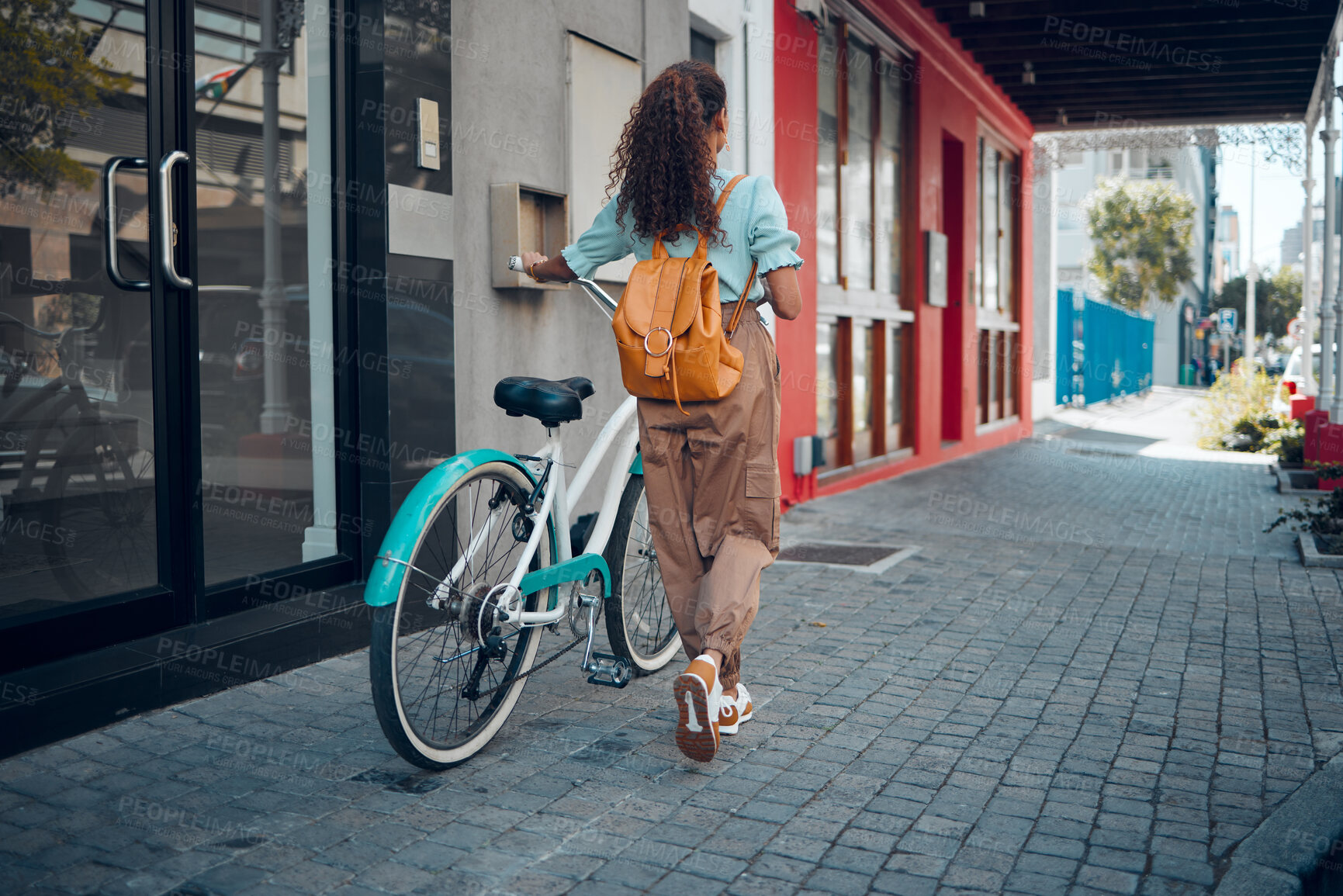 Buy stock photo Bike, city and back view of black woman, walking on street or urban road outdoors. Exercise, fitness and female student on bicycle ride, eco friendly transportation and cycling on asphalt in town.
