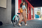 Happy, city and girl with a bicycle to travel to school, university or college to reduce carbon footprint outdoors. Smile, street and young student traveling or riding a cool bike in an urban town