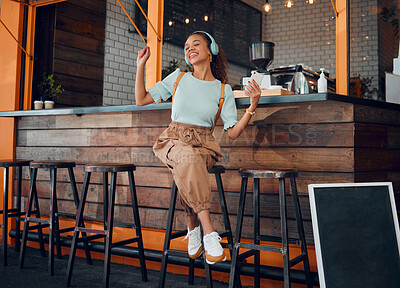 Buy stock photo Coffee shop, headphones and woman listening to music on smartphone for customer service experience and happy with wifi in cafe. Happy gen z girl or student relax in a restaurant using phone and audio