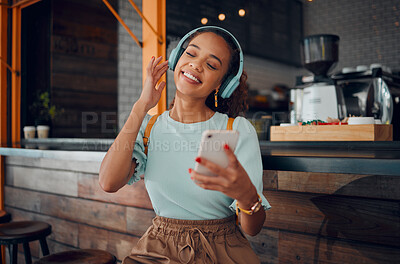 Buy stock photo Phone, music and coffee shop with a woman customer streaming audio on headphones in her local internet cafe. Mobile, radio and 5g with a young female using a subscription service in a restaurant