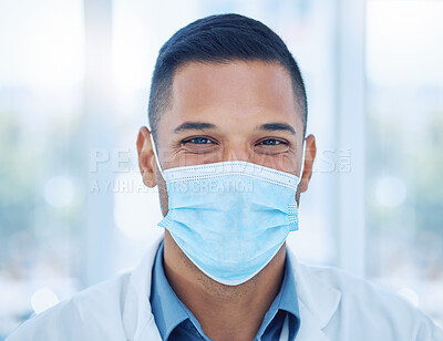 Buy stock photo Covid, face mask and portrait of a happy doctor in a hospital working, smiling and helping with healthcare expertise. Smile, compliance and medical worker with coronavirus safety protection in India